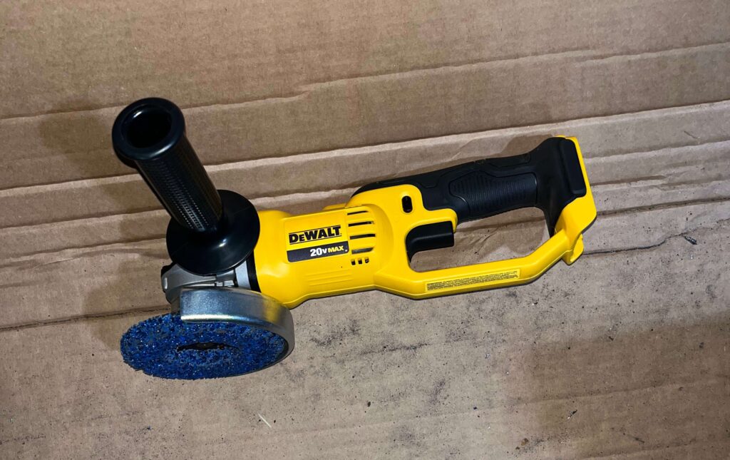 DeWalt 20V MAX cordless angle grinder sitting in a garage