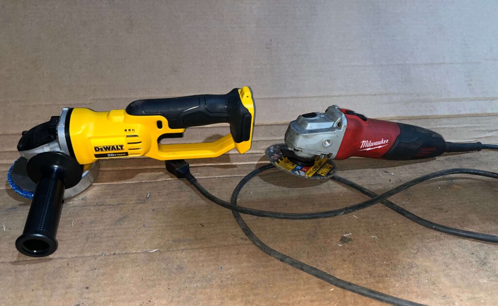 DeWALT 20V MAX cordless angle grinder and Milwaukee corded angle grinder next to each other in a garage